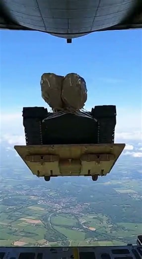 A realistic military operation showing a tank parachute drop from a C-130 cargo plane, detailed