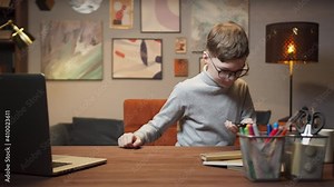 Kid boy using phone with AR 3D liar scan sensor, building mixed augmented reality model on table, student using vr technology on distance learning during lockdown, school remote learning.