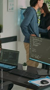 Vertical video: African american coder using computer to write code and develop algorithm program in software computer agency. Web developer working on user interface with html script and terminal Stock Video