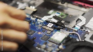 Clos-up hand of technician changes notebook computer battery manually at home, using a screwdriver and other equipment, DIY repair skills to extend the lifespan of electronic devices. Stock Video