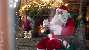 Tired santa claus eating cookies and drinking milk Stock Video