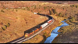 Beaming sunlight at Kyune! A Westbound Denver to Provo BNSF manifest makes its way through the curves of Kyune UT. A spectacular piece of railroad! Oct. 2023 Taken with the DJI Mavic 3 Pro | Railfan Dan