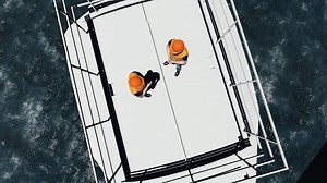 Two offshore workers on the top of the windmill, wind farm