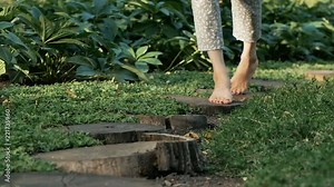 bare feet women go on the grass, on the path in the woods