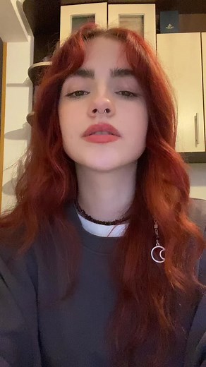 Stylish Red-Haired Individual in Cozy Kitchen Setting