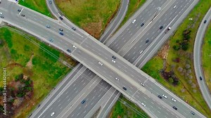 Aerial view massive highway intersection, stack interchange with elevated road junction overpass at early morning in American. This five-level freeway interchange carry heavy traffic, panorama. Stock Video