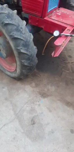 Detailed Close-Up of a Red Tractor's Rear Wheel