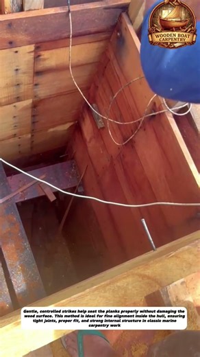 Using a Rubber Mallet to Secure Inner Planks in Wooden Boat Construction