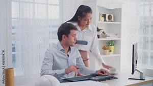 Asian architects doing construction drawing, using a computer and digital tablet at the desk, Designer writing graphics tablet, working at home