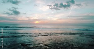 Aerial drone view of sunset on the ocean coast, sea, beach, sky, clouds. Sunset on the island of Bali, Indonesia