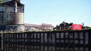 An Industrial iron structure and storage ruin with demolition sign.