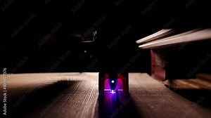 The process of laser wood cutting. A laser machine precisely carves lines on the surface, creating detailed and accurate designs. Perfect for themes of high-tech and manufacturing