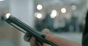 Woman surfing internet on cellphone