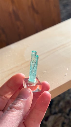 This tall thin 25 carat beryl crystal from Nigeria has a beautiful color with multiple terminations along the sides. This vibrant light blue/green beryl crystal was discovered in 2024 and we have been told it is vanadium & chromium bearing. The question whether to call it aquamarine or emerald is still in debate, so we are just calling it beryl for the time being. Many of these specimens have a darker color banding towards the termination, as seen in this one. It is slightly fluorescent and will