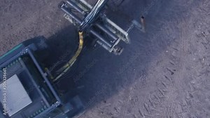 Top down aerial view of a tractor and trailer passing through frame with room for text.