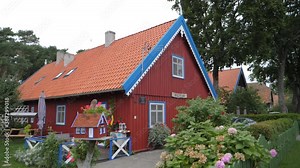 Beautiful architecture of Nida in Lithuania. Traditional coast regional houses of Lithuania. A small replica of the house is in the front.