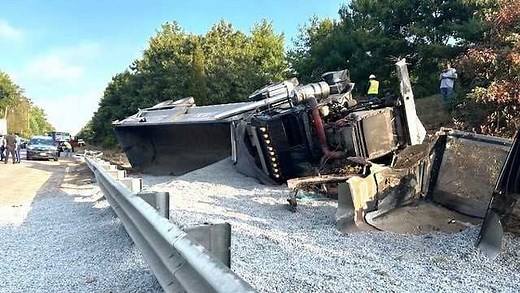 Dump truck filled with gravel rolls over on Interstate 495 in Raynham, Massachusetts