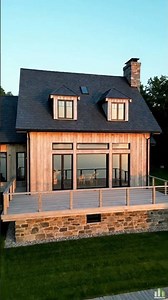Family lake house with larch cladding and slate roof