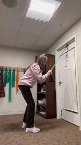 Standing alternating high to low core/cardio exercise using a band with door stop