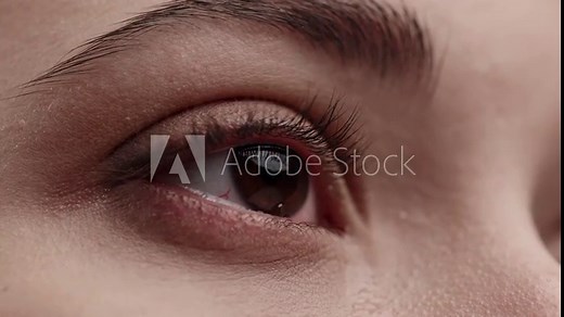 Close Up Macro Zoom Shot of a Crying Eyes. Close up of Caucasian woman crying with tear. Tears are Flowing Down. Young Beatiful brunette Female crying. Girl eyes having long nice Eyelashes.