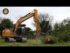 Case CX130C excavator cutting down trees with a circular saw