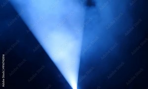 Spotlight Beam Through Smoke: A single, powerful spotlight cuts through a curtain of swirling blue smoke, creating a dramatic and ethereal effect. The soft, diffused light casts a mesmerizing glow on Stock Video