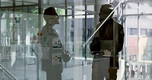 Handshake, silhouette and people in office, glass and partnership for business, thank you and talking. Holding hands, collaboration and colleagues in meeting, welcome and agreement in corporate