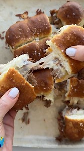 These BBQ Pulled Pork Sliders, stuffed with Monterey jack cheese and baked to bubbly perfection in butter-brushed Hawaiian rolls, are an ideal Fourth of July treat! | Fed and Fit