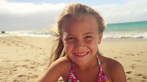 Close up of a young girl smiling as she looks into the camera