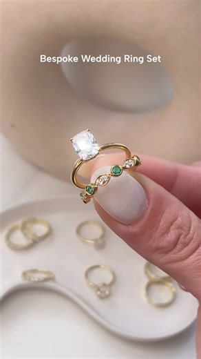 Stop scrolling. This is _the_ set. 2ct elongated cushion with a hidden halo, paired with a diamond & green emerald wedding band in a modern rubover (bezel) setting. Bold contrast, secret sparkle, pure bridal energy. DM us to begin your bespoke journey! | Harmony Jewels London