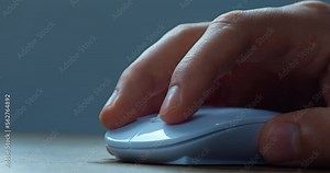 Close up hand of office worker actively using a computer mouse while working in the office. The male employee hand uses the mouse to work at the computer. White computer mouse, close-up macro Stock Video