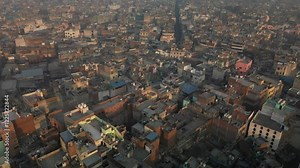 Aerial view of vibrant cityscape with dense rooftops and modern buildings, New Delhi, India.