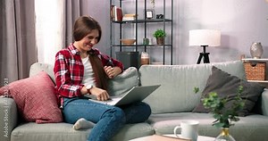 Caucasian woman having shopping on internet. Woman is holding credit card and using laptop computer. Online shopping concept. Picture showing pretty woman shopping online with credit card