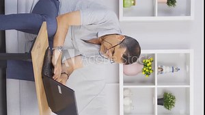 Vertical video of Old man chatting online on laptop. Old man spending his free time.