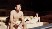 A couple relaxing in a sauna.