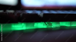 Glowing keyboard hackier style glittering at the night workplace with different light colors