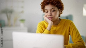 Sad serious woman freelancer programmer thinking having difficulties coding creating apps on laptop. Focused african american girl try to solve problem looks at screen. Remote distant freelance work.