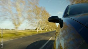 Driving a car, windshield reflection. Hood side reference. Mounted camera, front view. Black car ride. Country road, trees on the side, blue sky, day. Real Time Speed. HD. Right side wheel driving UK