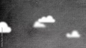 White small vector clouds that hover across a dark black lit sky containing a fabric like overlay motion background.
