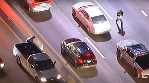 Video shows knife-wielding man run across L.A. freeway and into traffic before police capture