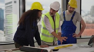 Professional construction engineers team using blueprint of project plan brainstorming and working together at construction building, Architecture and building construction concept