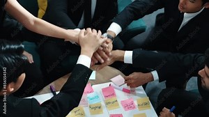 Top view of business people putting hands together and clapping hands to celebrate project while using kanban task board to manage time. Startup team stacking hands together. Closeup. Directorate.