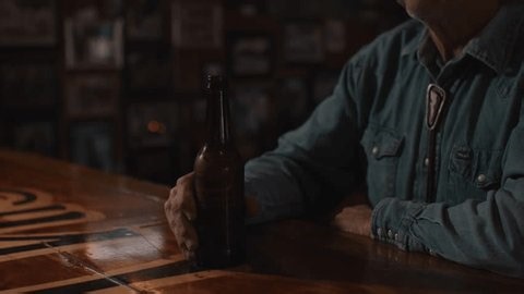 clip-3958031341-man-mustache-wearing-cowboy-hat-sitting-bar