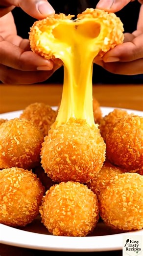 Fried Cheese Balls Crispy fried cheese balls with gooey centers, ready in 15 minutes. Ingredients 2 cups grated cheese (cheddar or mozzarella) 2-3 tbsp cornstarch 1-2 eggs Oil for frying Steps Grate cheese, mix with cornstarch and beaten eggs into sticky dough. Roll into small balls; chill if sticky. Fry in hot oil until golden and crispy. Drain and serve hot. #FriedCheeseBalls #EasyRecipes #QuickAppetizers #CheeseLovers #SnackIdeas | Easy Tasty Recipes