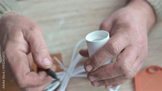 A person shows how to install a lamp socket using basic tools.