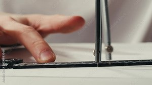 Close-up of compass drawing on white paper macro. Making some circle and measuring distance on white list by compass close-up. Drawing and sketching lessons concept.