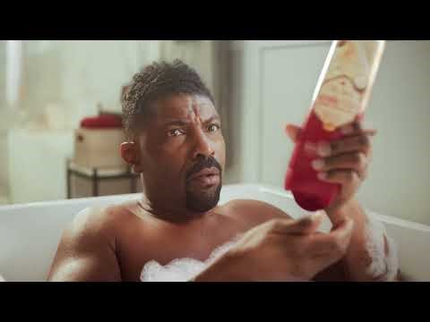 Old Spice Man in the middle of the foam in a bathtub commercial