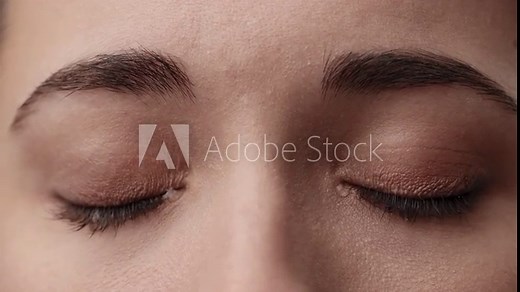 Close Up Macro Zoom Shot of a Crying Eyes. Tears are Flowing Down. Young Beatiful brunette woman crying. Girl eyes having long nice Eyelashes. Close up of Caucasian Female crying with tear.