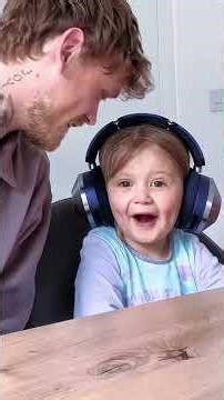 Charlie Lenehan with his daughter reacting to the new songs