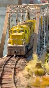 HO Scale Splitrock Mining Company ALCos lead a train across this incredible layout. Find them on FB